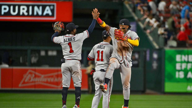Apr 3, 2023; St. Louis, Missouri, USA; Atlanta Braves right fielder Ronald Acuna Jr. (13) shortstop Orlando Arcia (11) and second baseman Ozzie Albies (1) celebrate after the Braves defeated the St. Louis Cardinals at Busch Stadium.